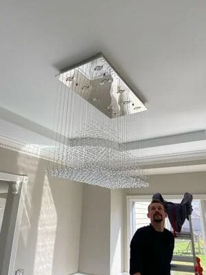 Recessed LED chandelier with crystal beads installed in ceiling opening