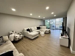 Recessed ceiling lights in modern living room with wood floors and contemporary furnishings